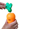 Hand holding and removing lid of makspatch carrot toy